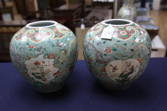 A pair of Chinese famille verte ovoid jars and covers, late 19th century, 31cm, one cover repaired